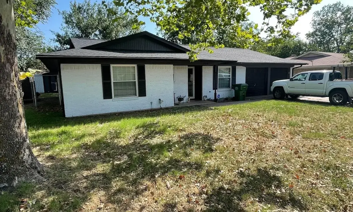 Professional roofing crew working on a residential roof in Box Elder